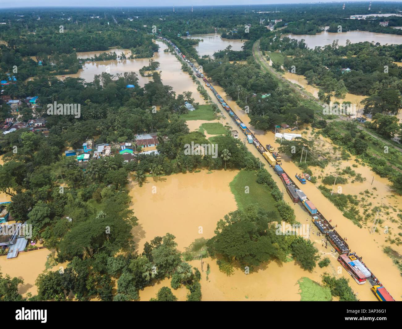 Aerial view of flooded highway and submerged village with stranded ...