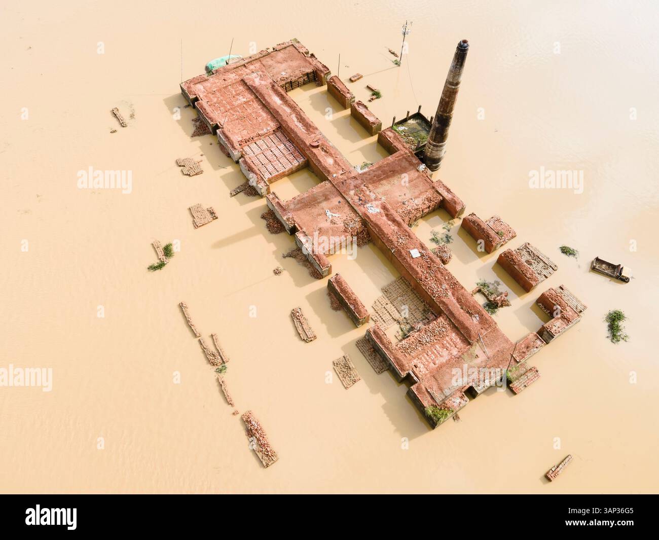Aerial view of a flooded village with submerged buildings and vehicles ...