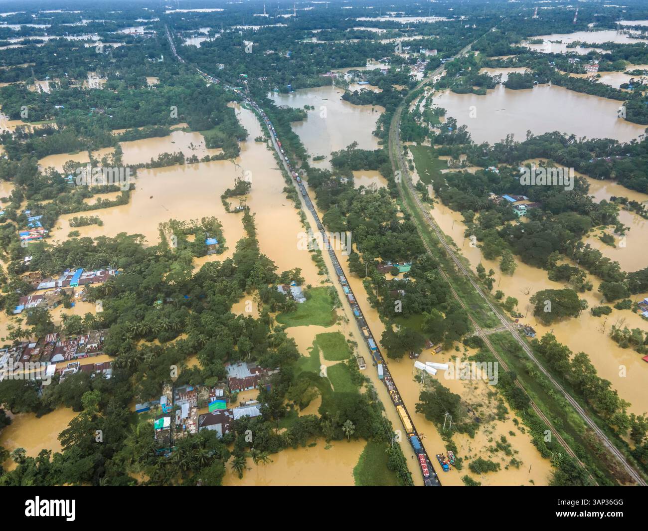 Aerial view of flooded highway and submerged village with stranded ...