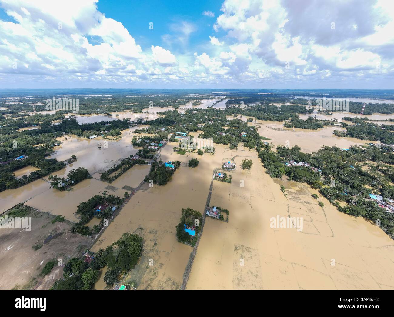 Aerial view of a flooded village with submerged homes and fields ...