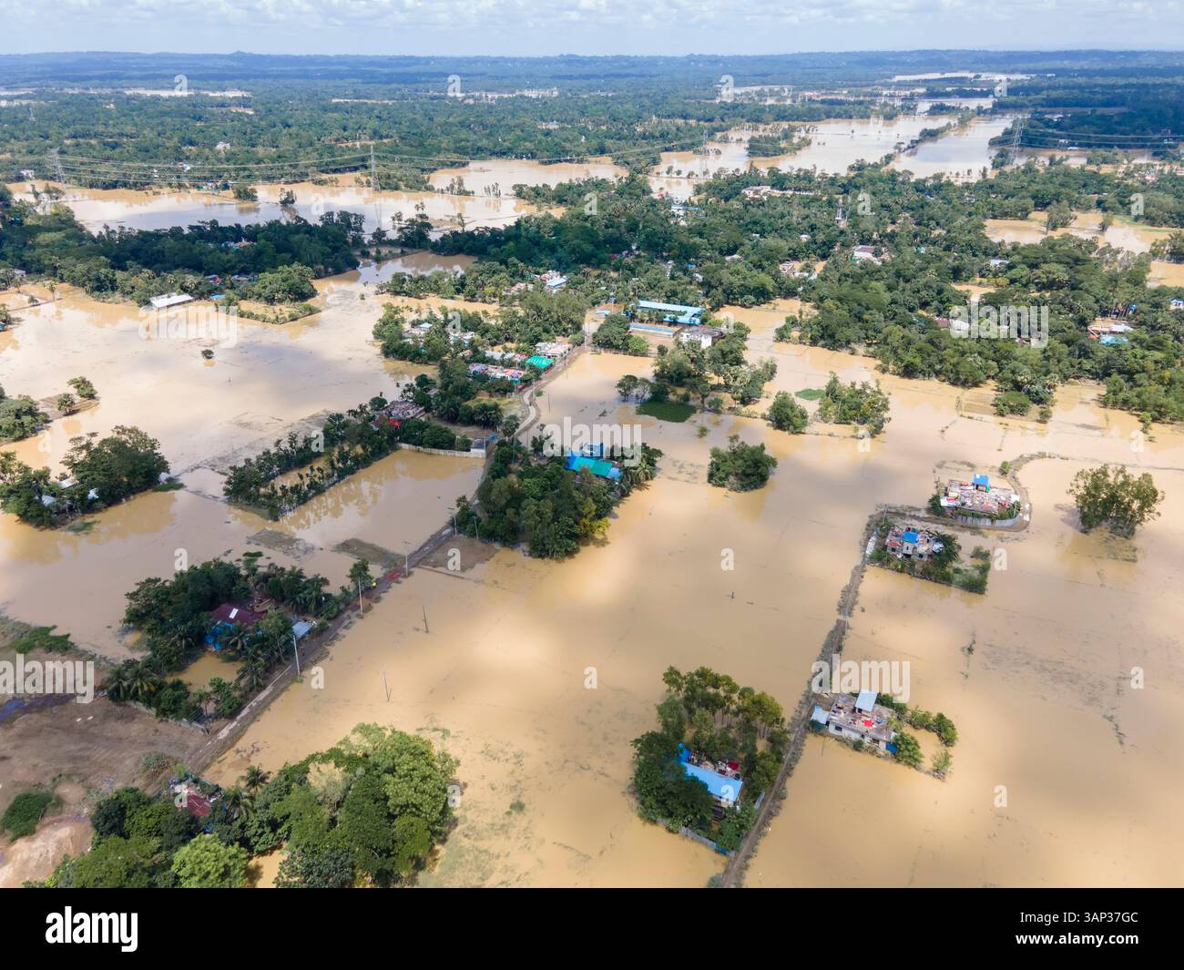 Aerial view of flooded village with submerged homes and fields ...