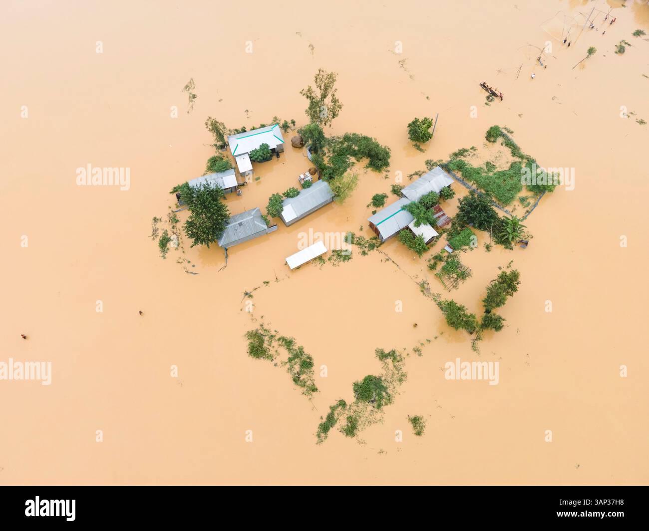 Aerial view of flooded village with submerged houses and roads amidst ...