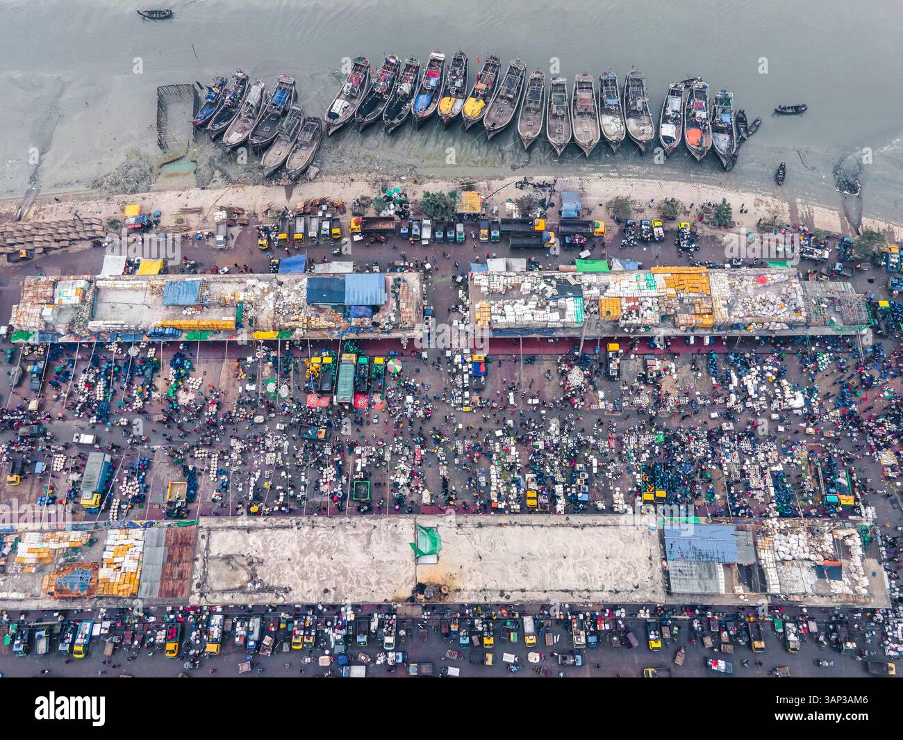 Aerial view of bustling fishery market with fishing boats along the ...