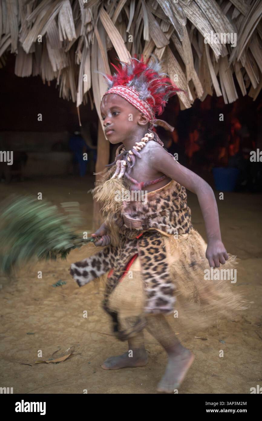 Portrait of a boy in front of a temple, dressed in a ritual costume ...