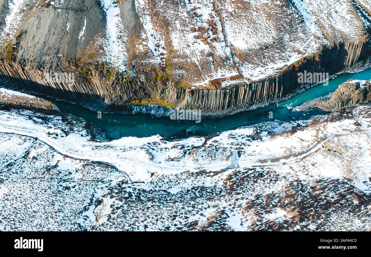 Aerial drone top-down view of Studlagil Canyon, river and pillar shaped ...