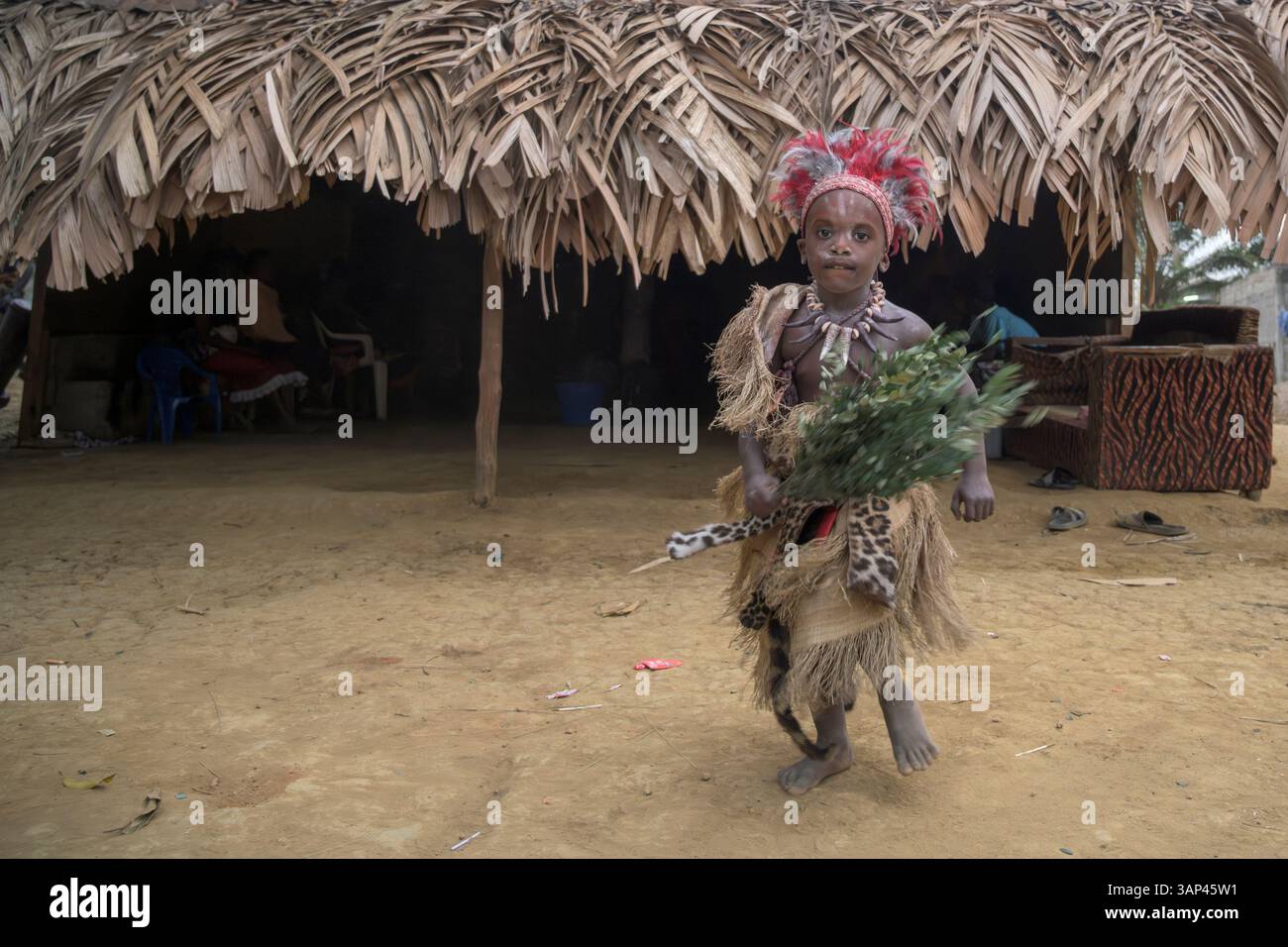 Portrait of a boy in front of a temple, dressed in a ritual costume ...