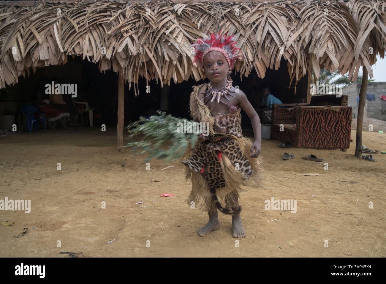 Portrait of a boy in front of a temple, dressed in a ritual costume ...