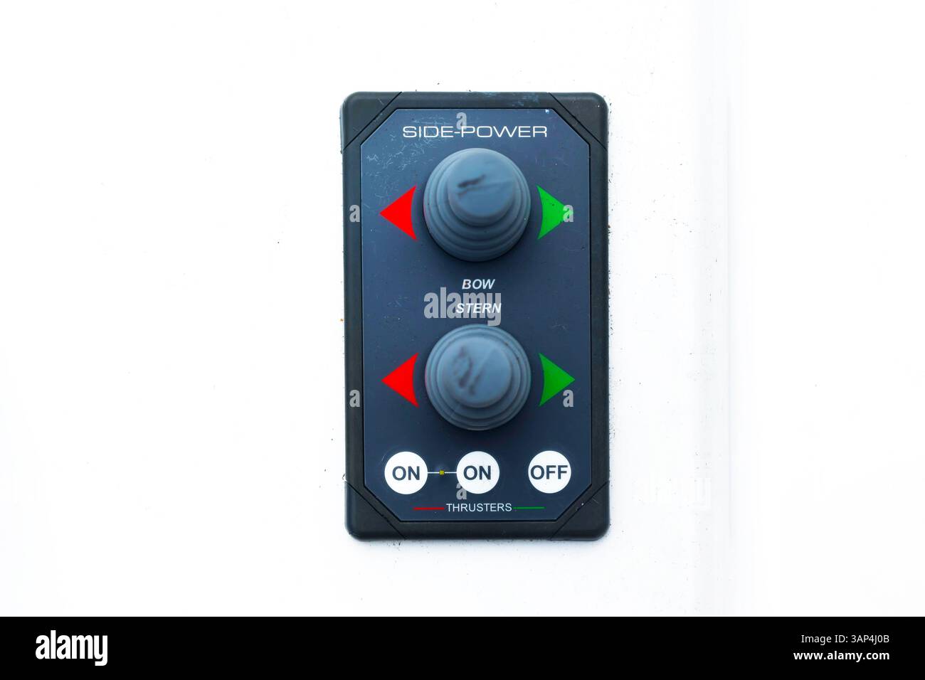 The control console of the bow and stern thrusters of a motor yacht with buttons and joysticks, close-up. Stock Photo