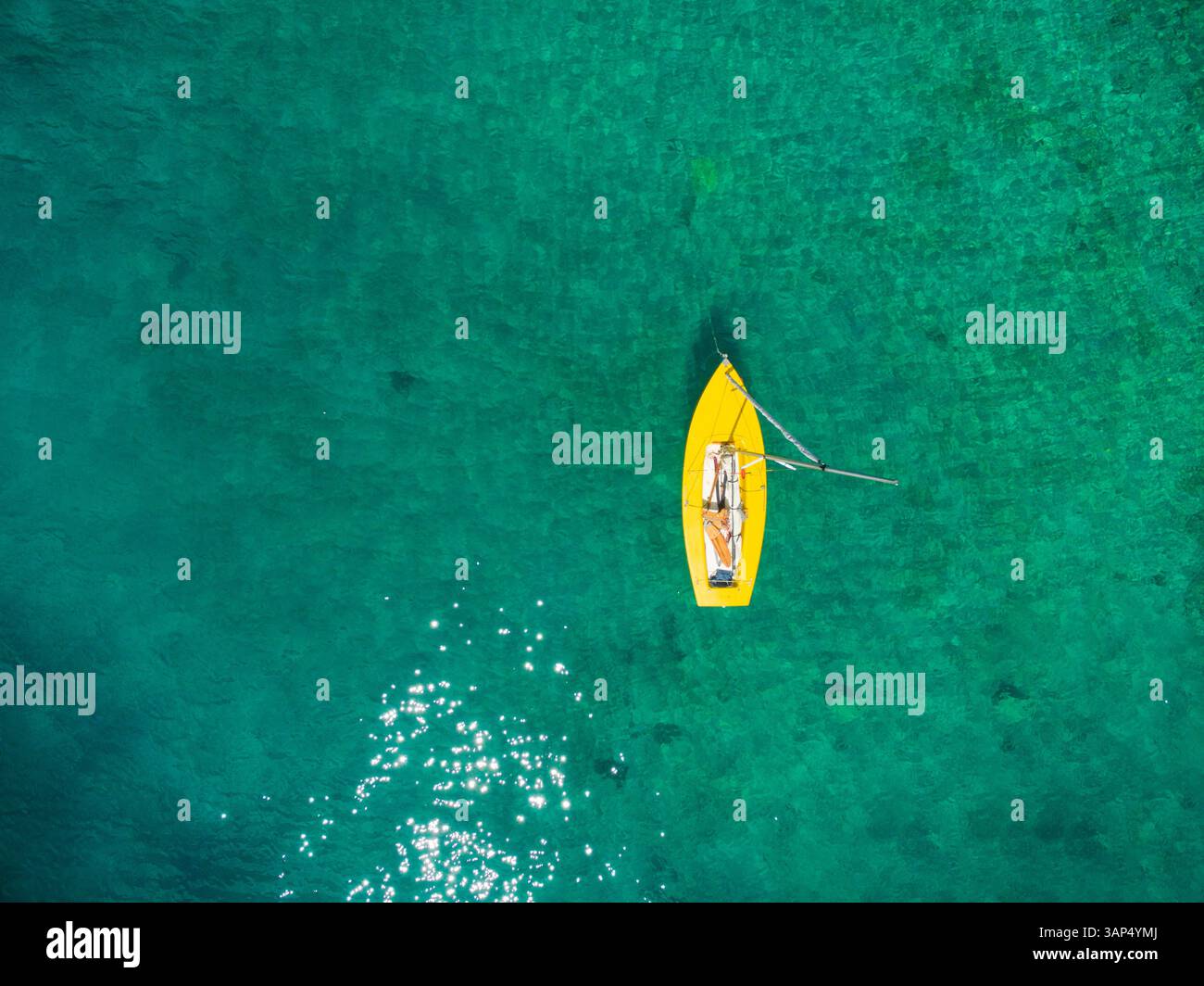 Aerial view of yellow boat floating at the sea Stock Photo - Alamy