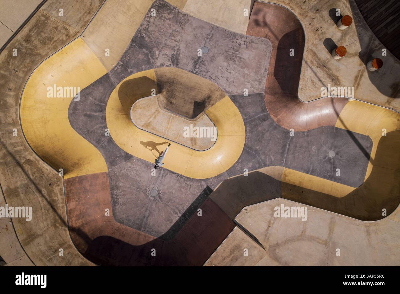 Aerial view of dynamic skatepark with skateboarders and intricate ...