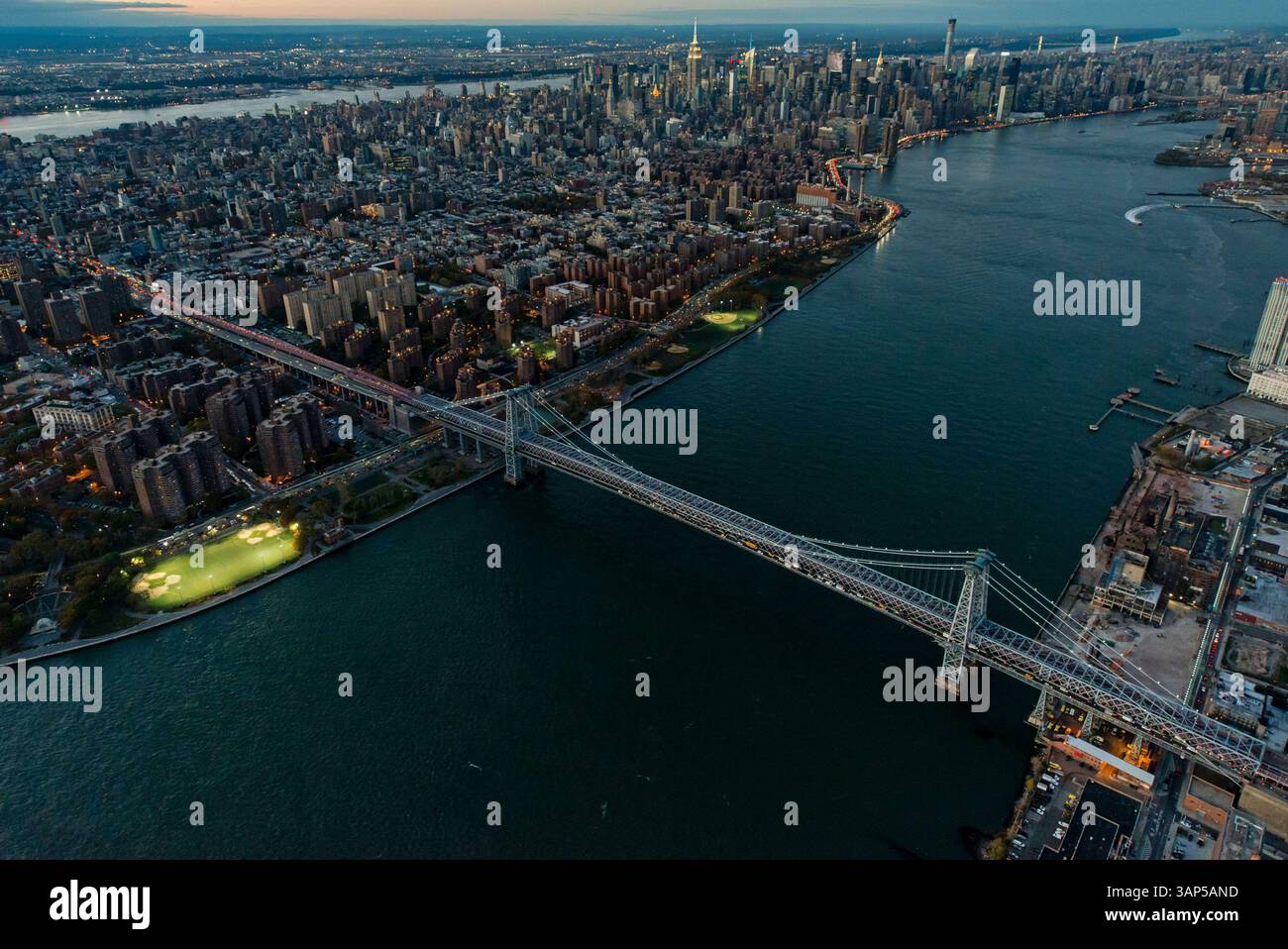 aerial-view-of-brooklyn-bridge-illuminated-at-dusk-with-a-beautiful