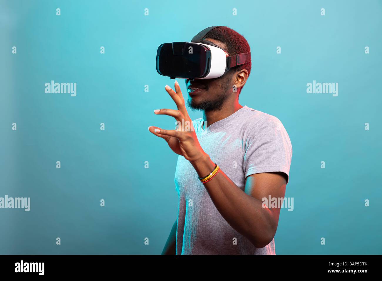 Black man exploring virtual reality, using goggles to interact with ...