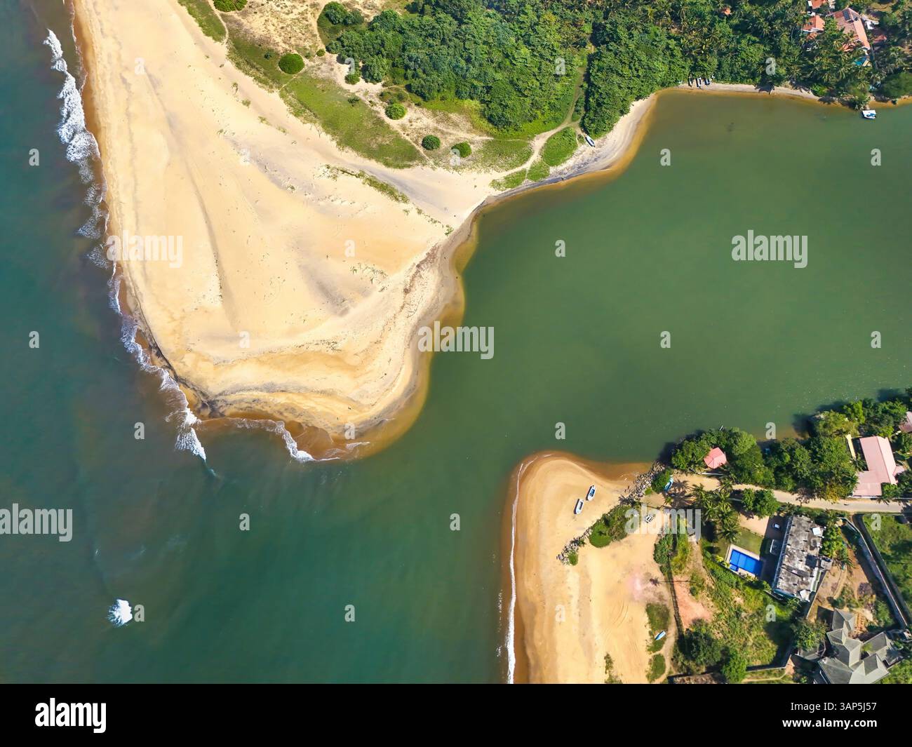 Aerial view of estuary with river Maha Oya flowing into Indian Ocean ...