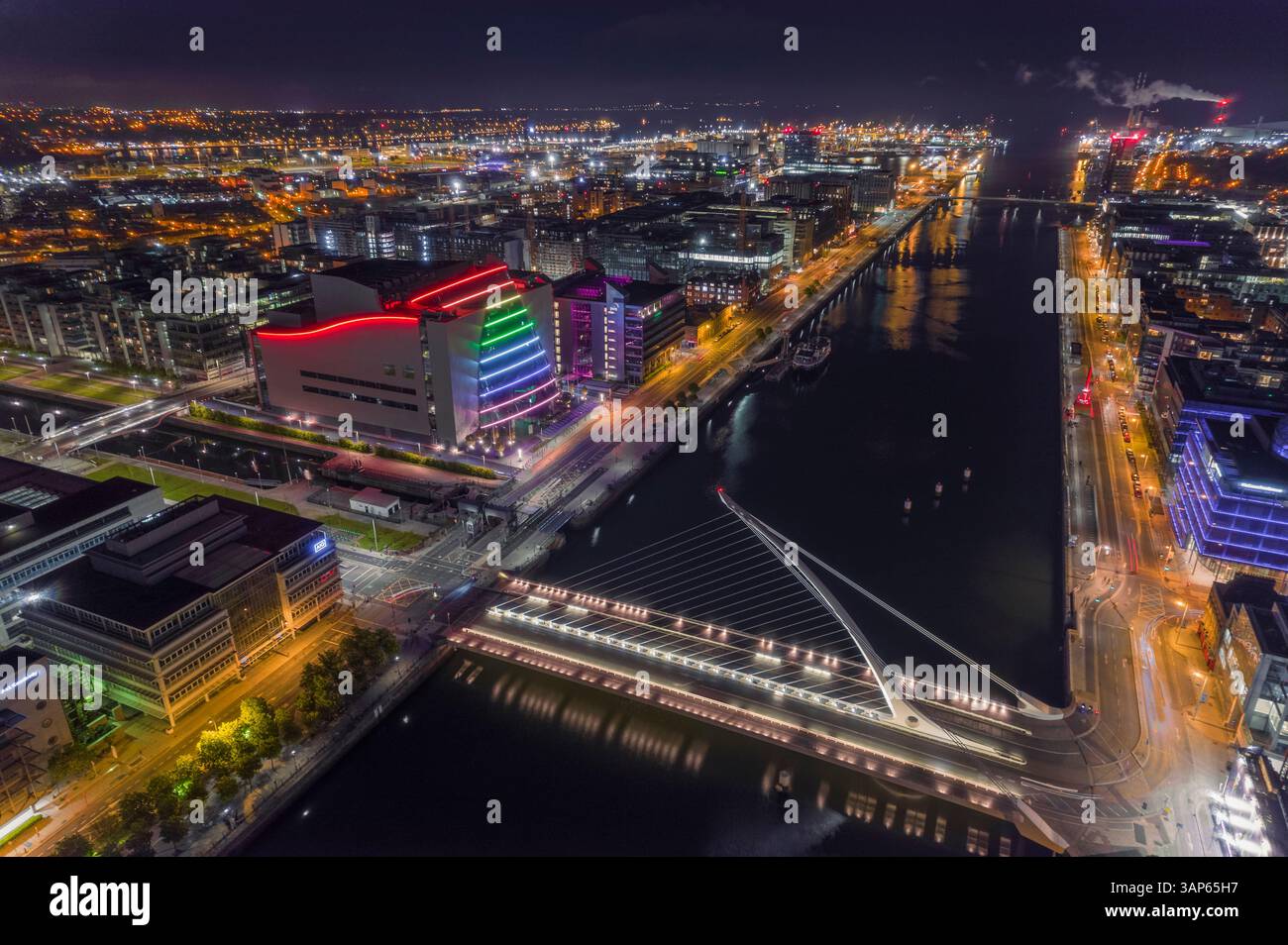 Aerial view of Samuel Beckett Bridge crossing the Liffey River at night ...