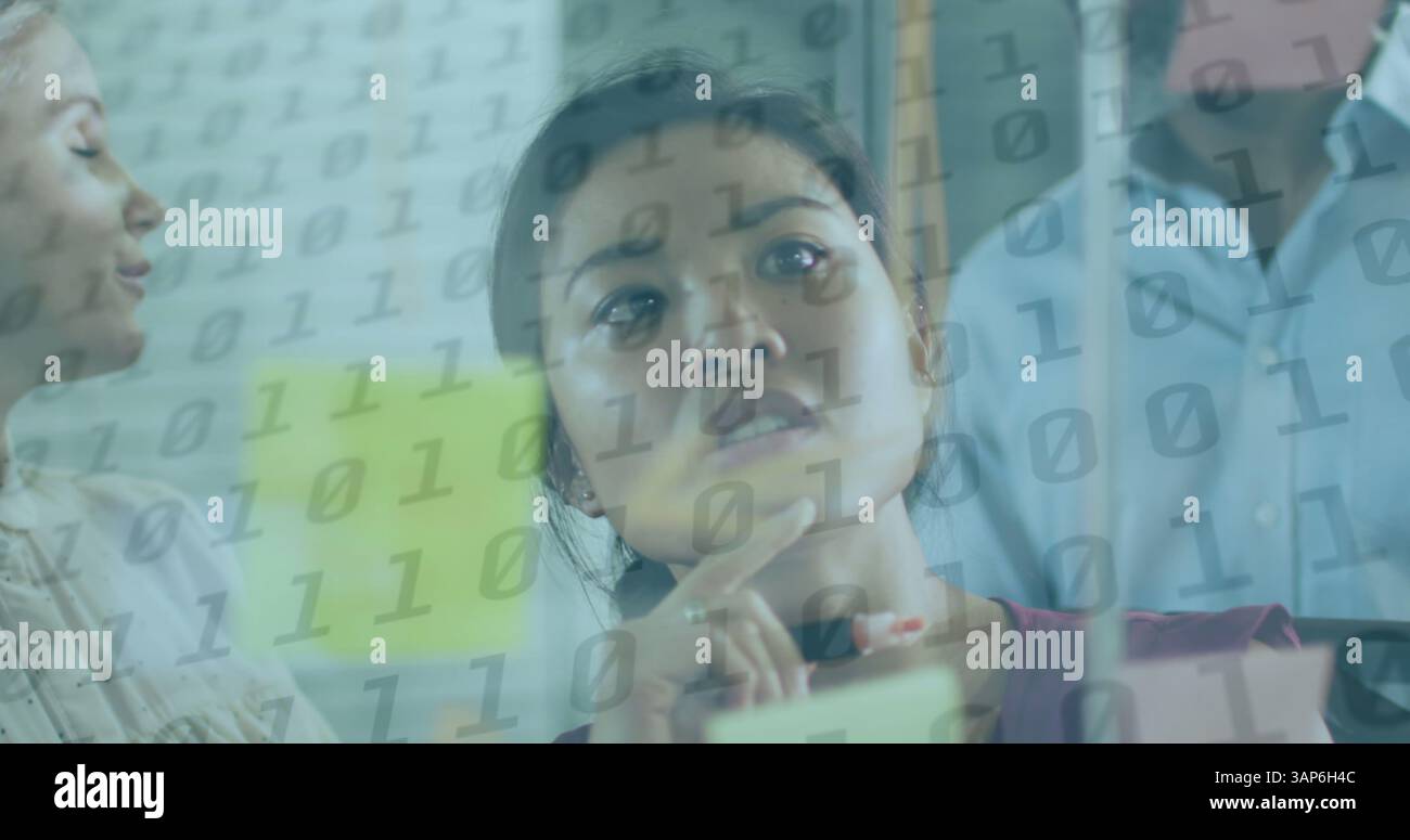 Image of binary coding over diverse business people taking notes Stock Photo
