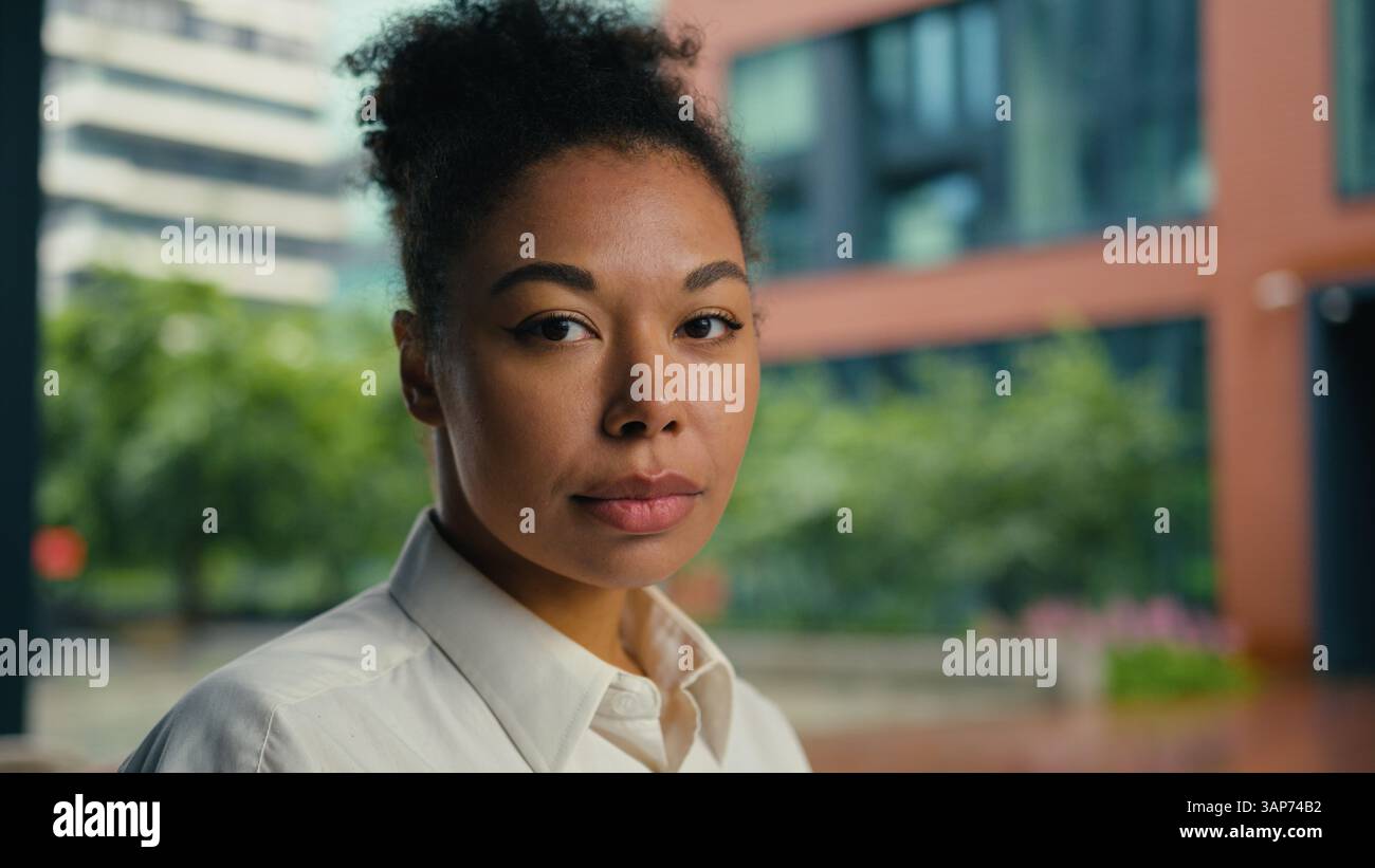 Side view confident successful African American woman turn head looking at camera serious face portrait sad upset girl female businesswoman business Stock Photo