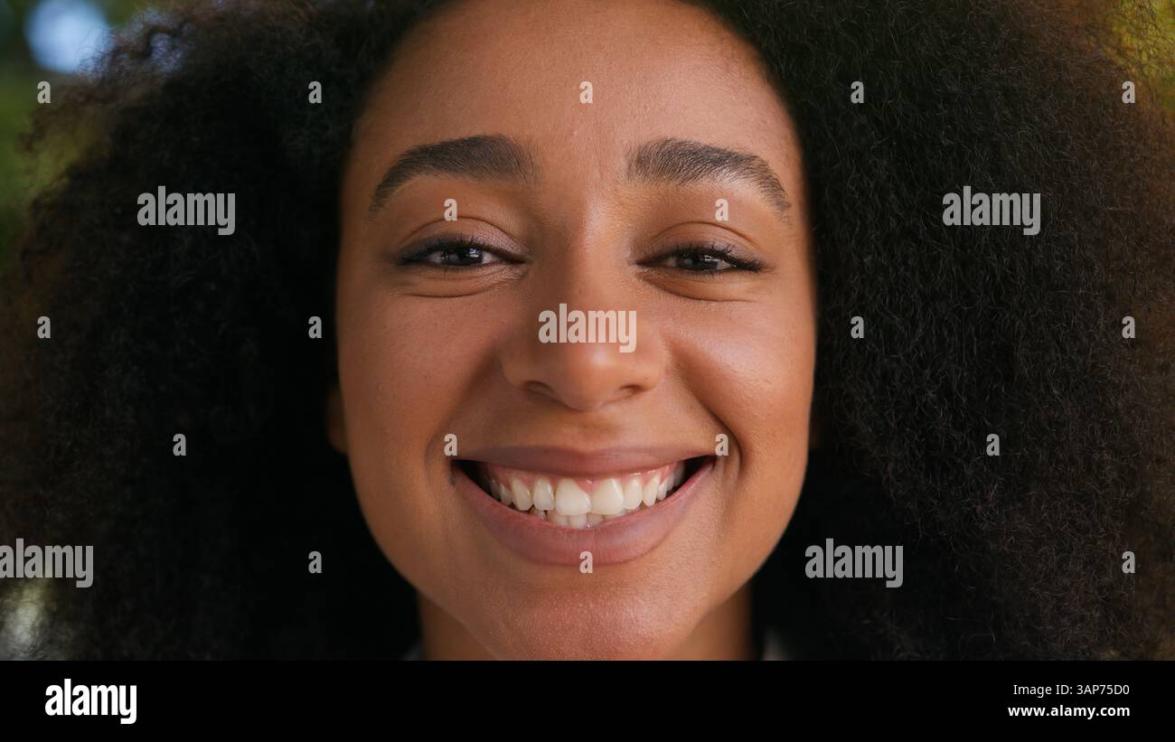 Close up face African American woman smiling laughing positive funny female girl businesswoman portrait happy student lady health teeth smile looking Stock Photo