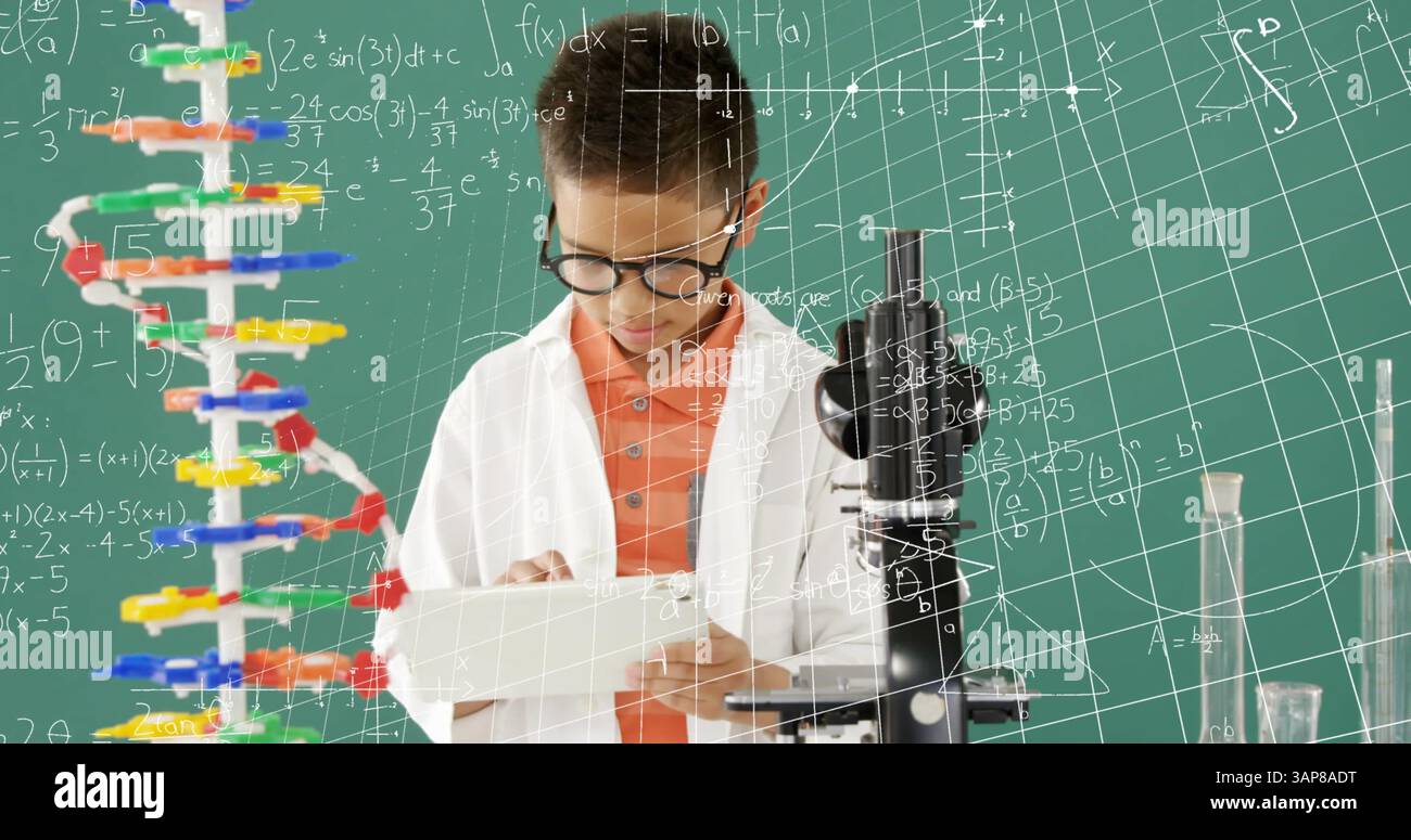 Image of mathematical formulae over smiling schoolboy using tablet Stock Photo