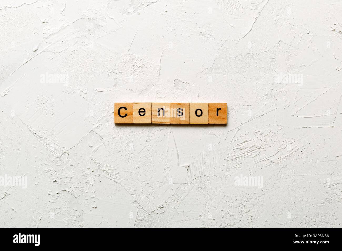 Censor word written on wood block. Censor text on cement table for your desing, concept. Stock Photo
