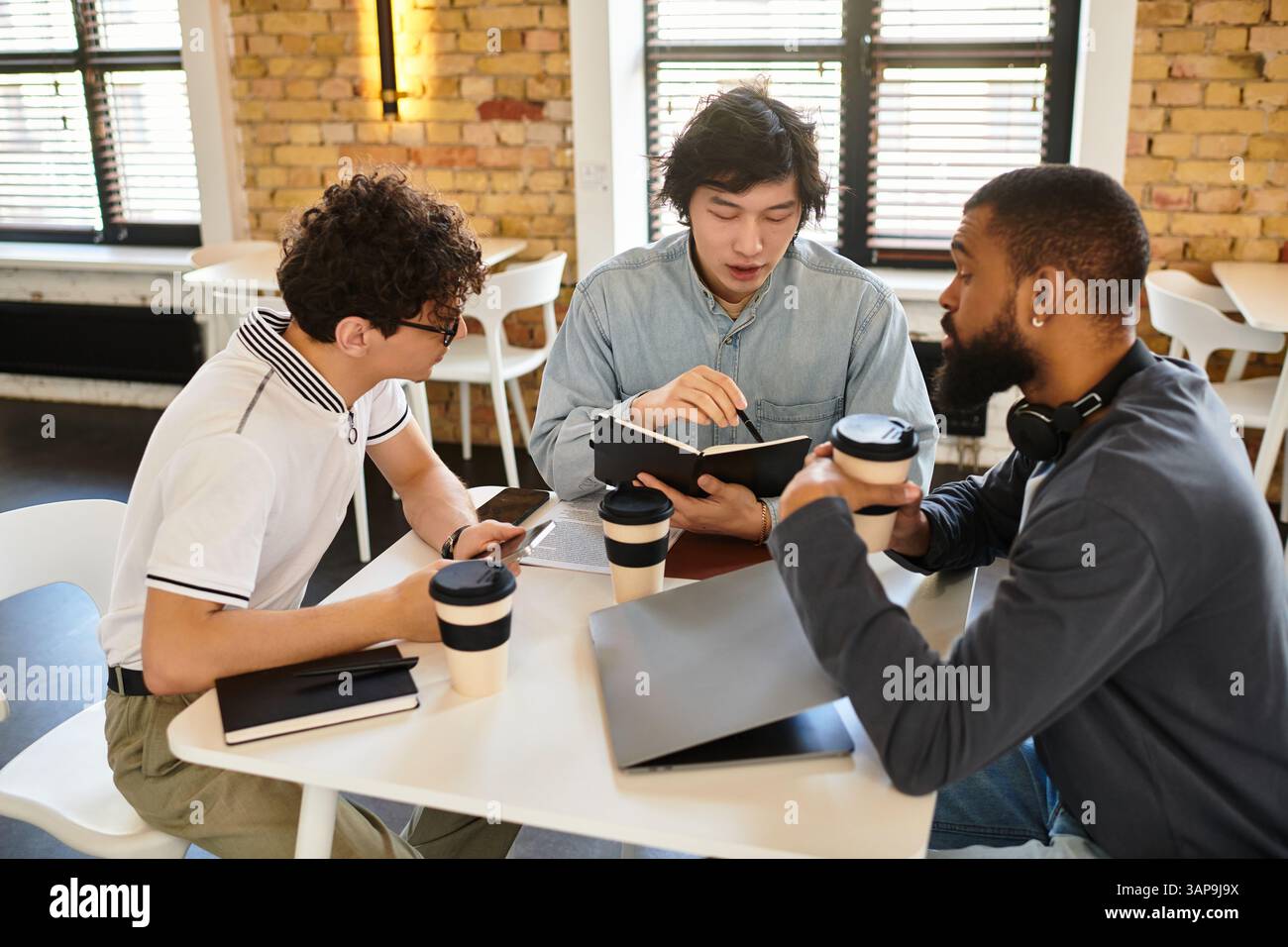 Three Professionals Collaborating Three professionals collaborate at a bright office table, sharing notes ...
