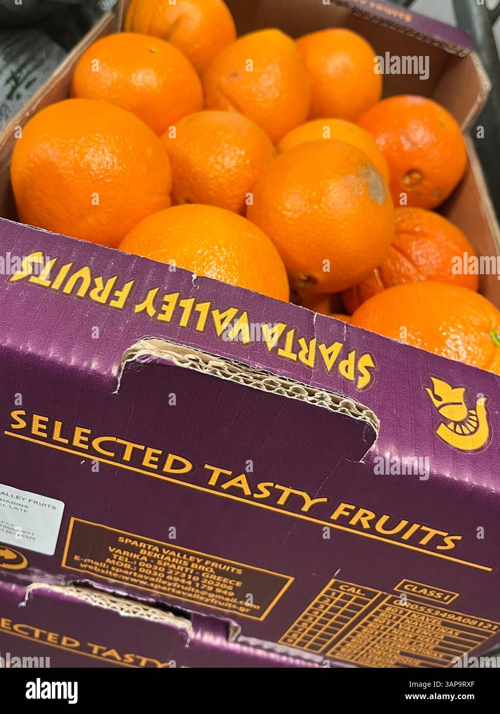 Oranges in cardboard crate by Sparta Valley Fruits, a Greek producer based in Sparta, known for high-quality citrus from Laconia - Smartphone Captured Stock Image