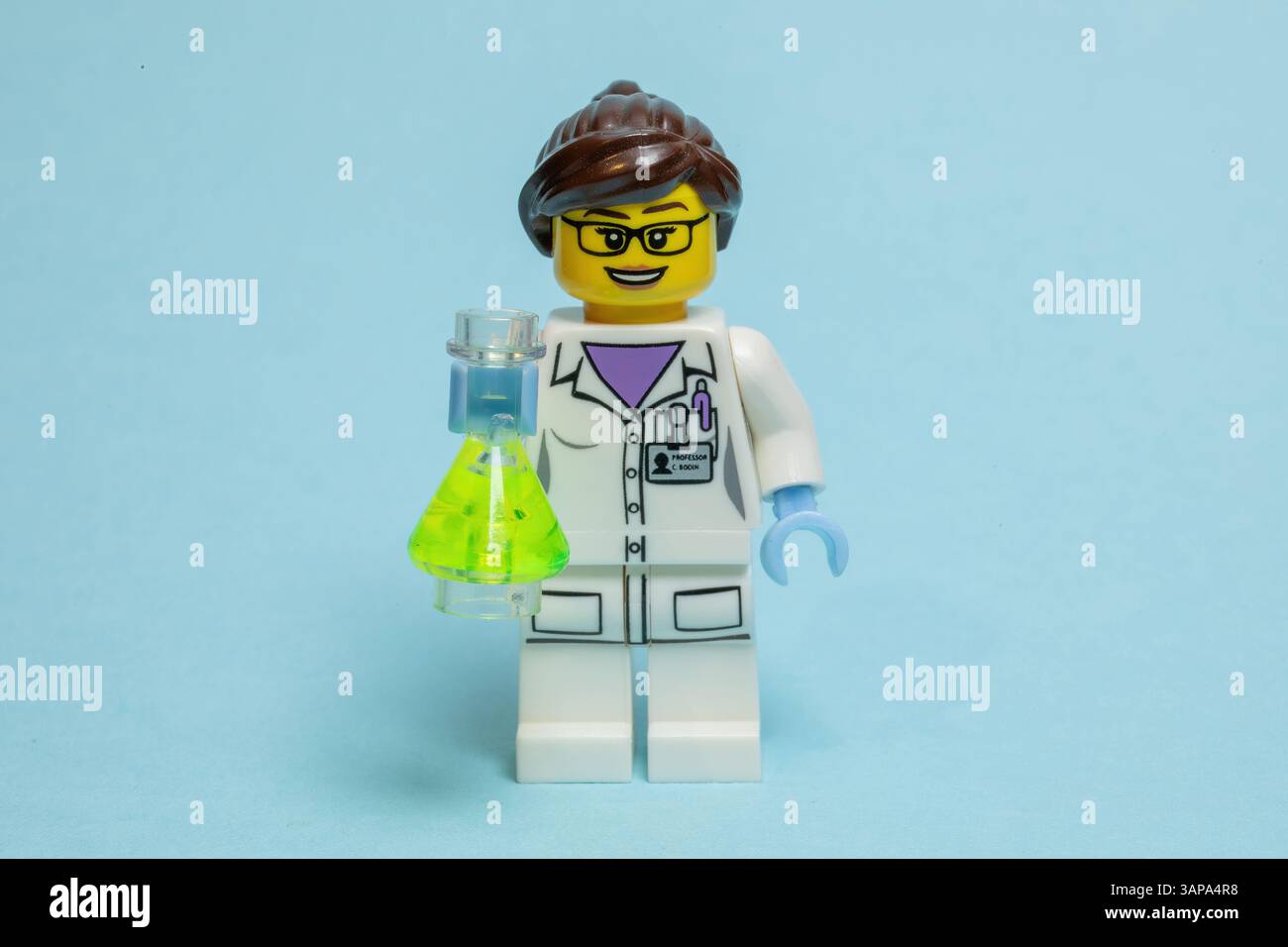 Toy model of a female scientist holding a beaker Stock Photo