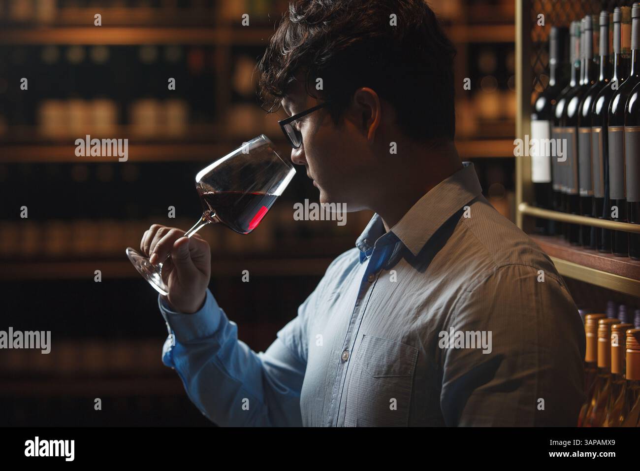 Man Tasting Wine in Wine Cellar Stock Photo