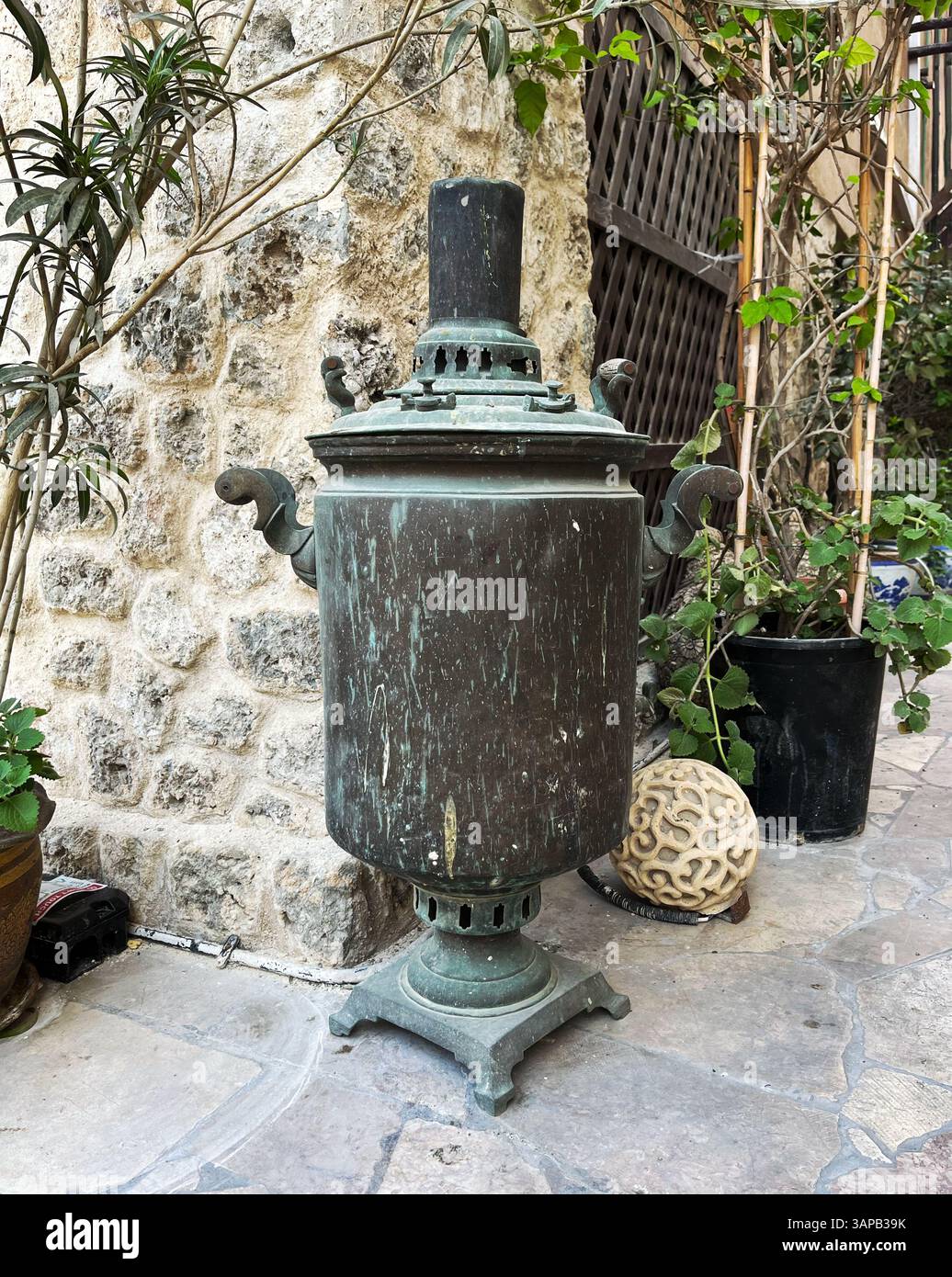 Middle Eastern Samavour An antique metal samovar in an atmospheric Middle Eastern courtyard ...