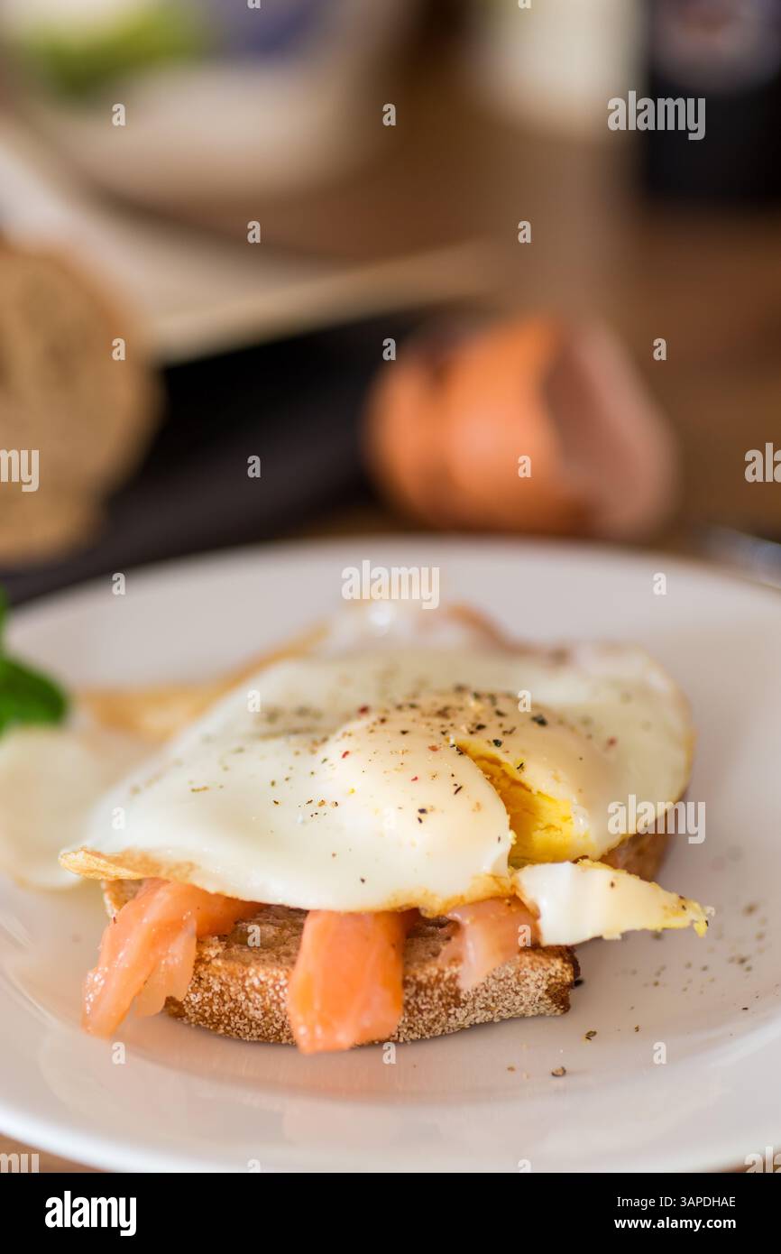 Diet breakfast with cooked egg and lightly salted red fish. Stock Photo
