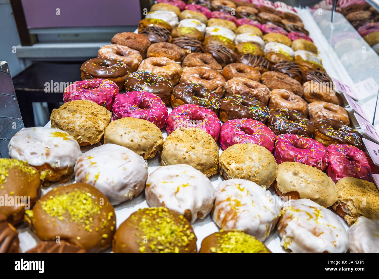 Colorful Assorted Donuts Displayed in Bakery Shop Showcase Stock Photo ...