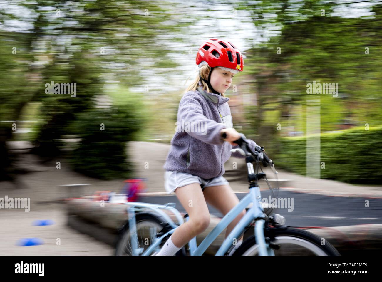 Students Ride Bicycle DEN HAAG - Elementary school students ride a bicycle with a bicycle ...