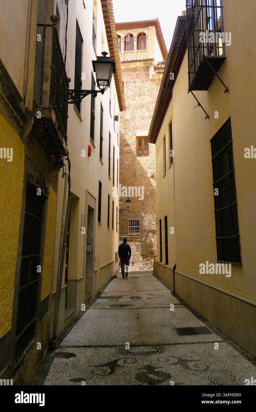 Albaicin, Granada. A man walks in a narrow alley at the Albayzin district. Stock Photo