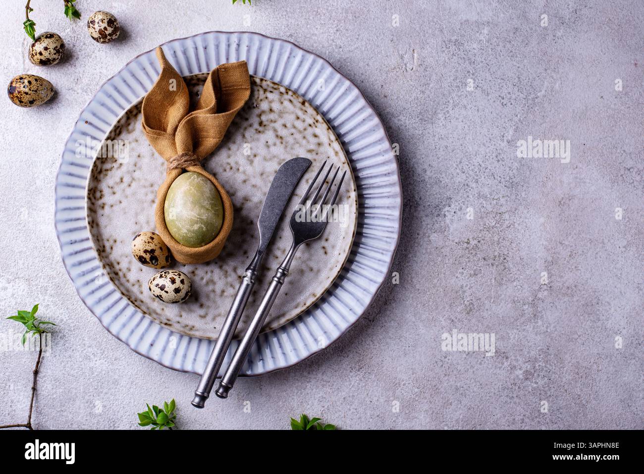 Elegant Easter table setting with painted egg Stock Photo
