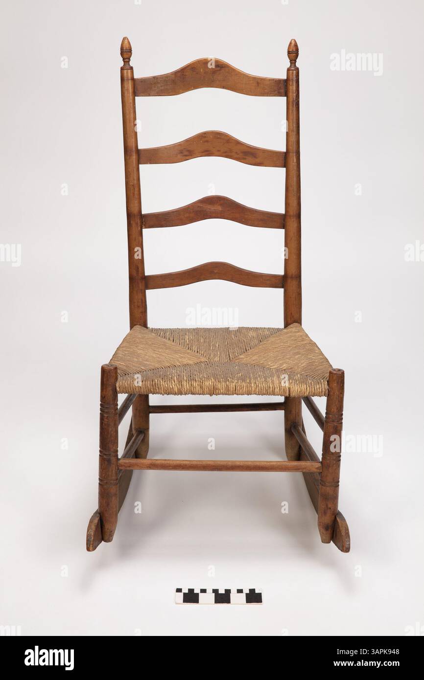 This German-American style child's wooden rocking chair features peg ...