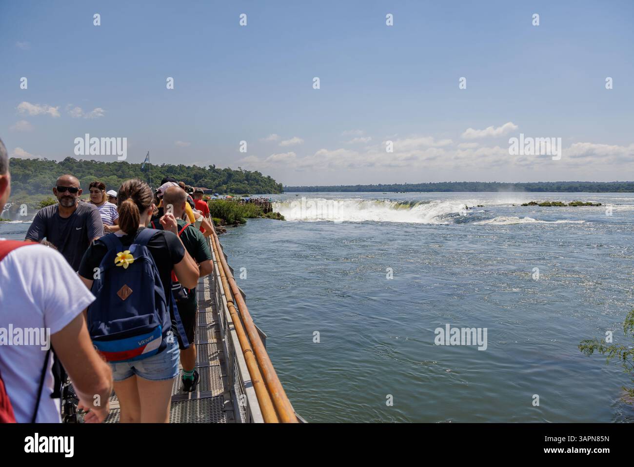 Puerto Iguazu, Misiones, Argentina - April 5th, 2025: Tourists watching the Devil's Throat waterfall at Iguazu Falls. Stock Photo