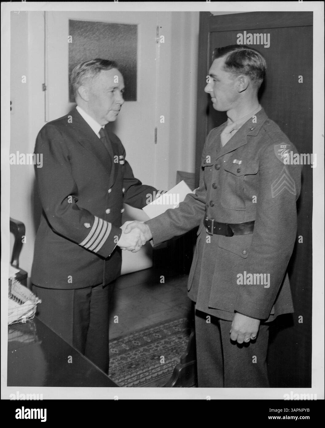 Marine Sergeant Neuschwander of Redwood Falls receives a commendation ribbon for outstanding service during his duty in the Marshall Islands with the United States Marine Corps wire crew. Stock Photo