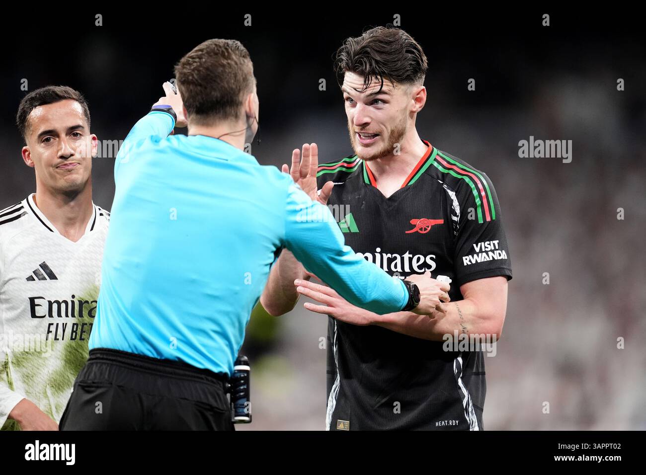 Arsenal's Declan Rice (right) speaks to referee Francois Letexier ...