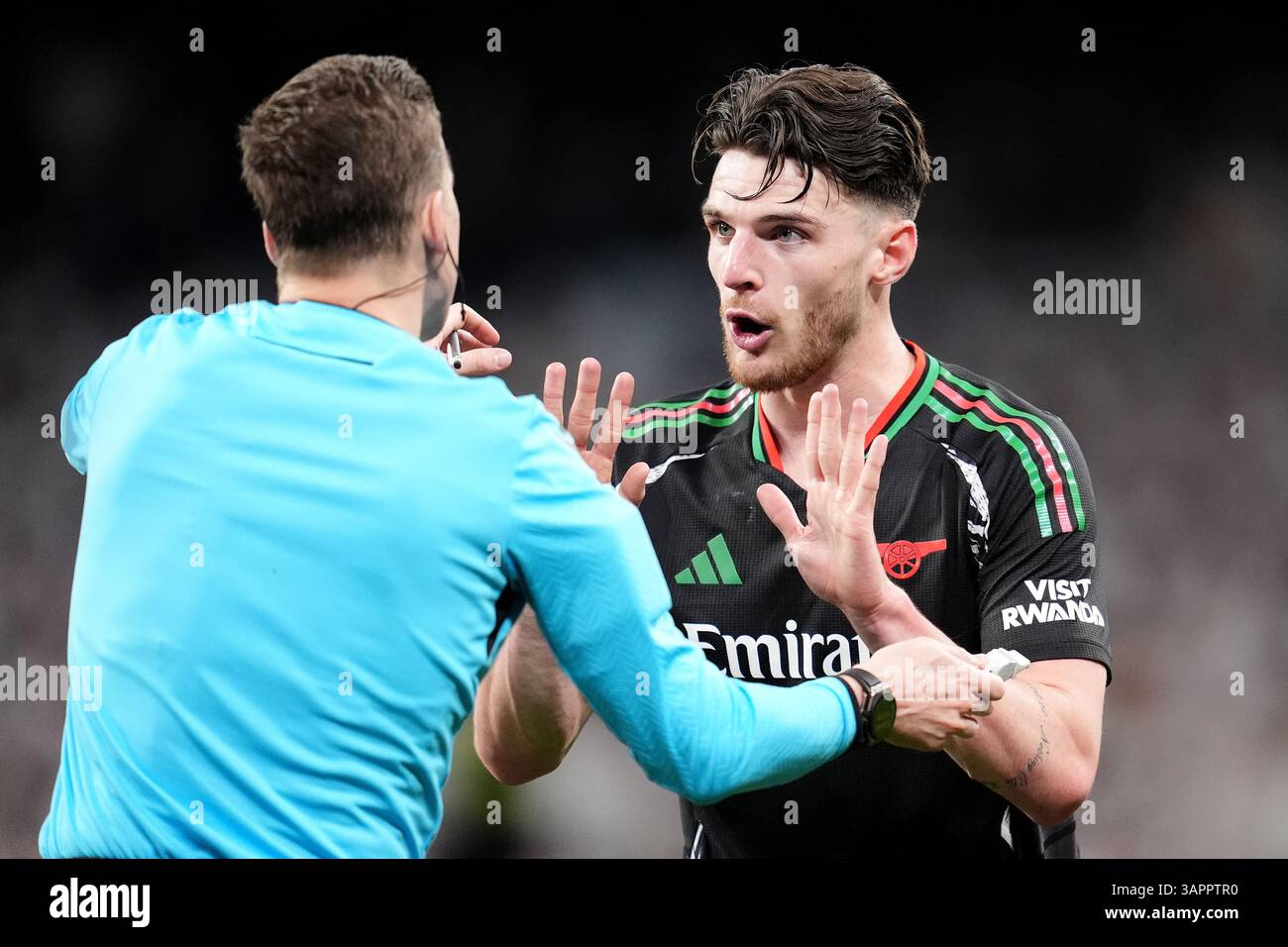 Arsenal's Declan Rice (right) speaks to referee Francois Letexier ...