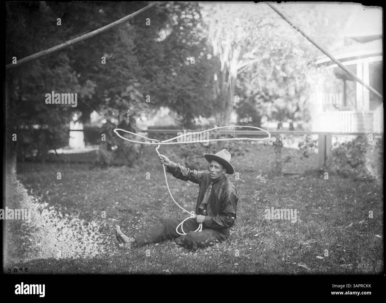 Photograph by Lee Moorhouse of L.E. McCoy performing trick roping Stock ...