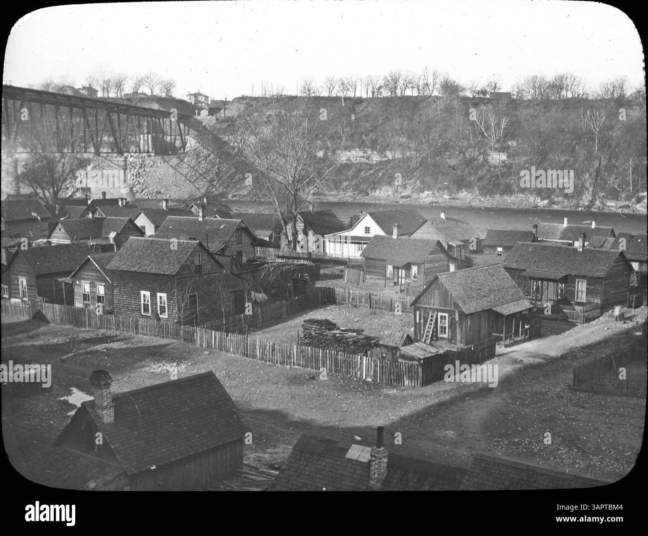 This historical photo showcases the early days of Bohemian Flats, located along the Mississippi River in Minneapolis. The area was home to immigrant communities, predominantly Czech, and features a glimpse into the early settlement and daily life along the river. Stock Photo