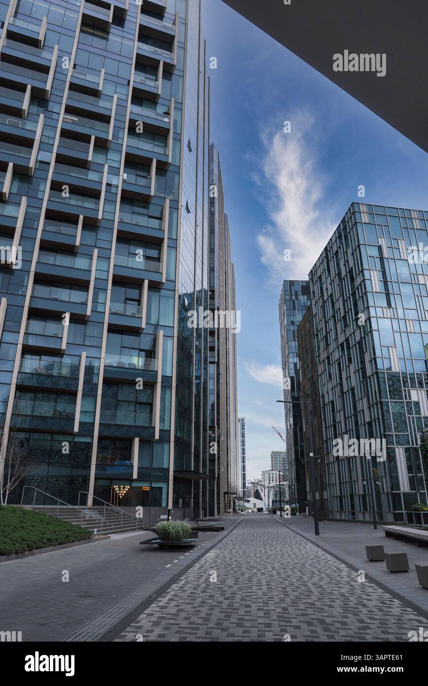 Picture of Tall glass buildings with geometric designs, a paved pathway ...