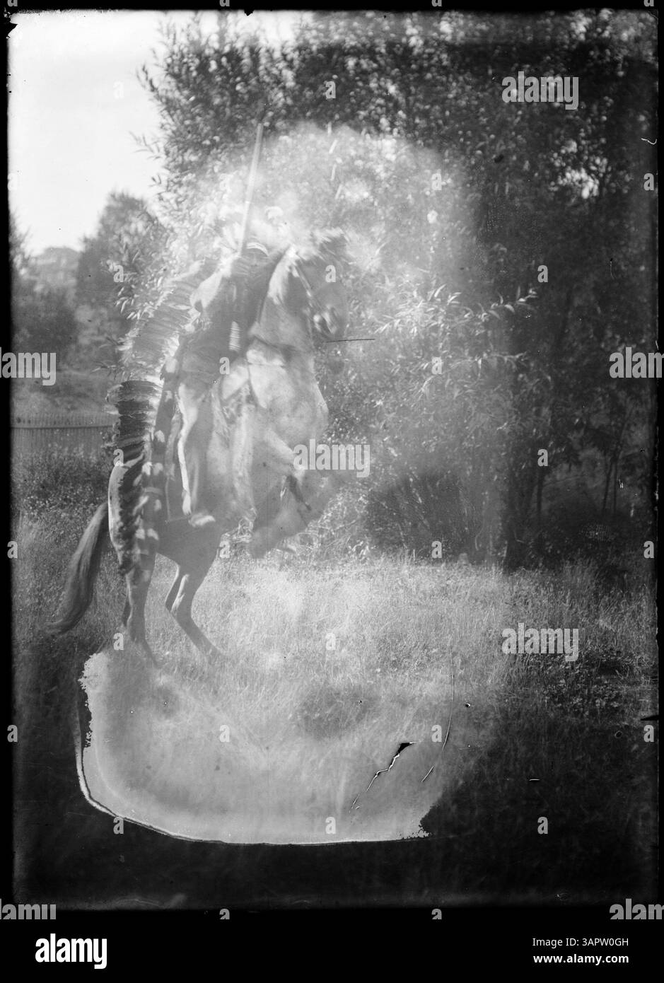 This photograph shows a Native American man dressed in traditional ...
