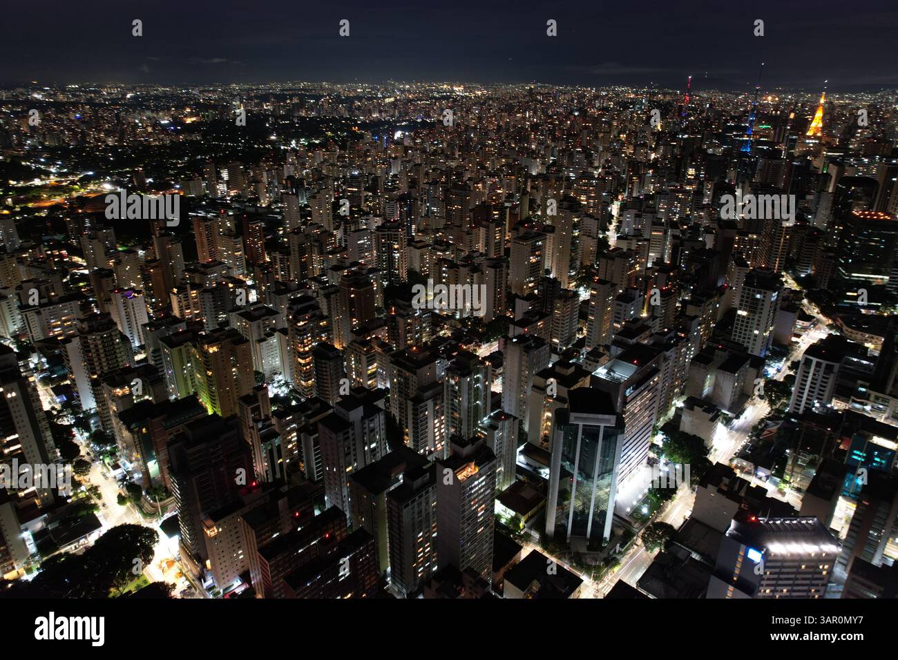 City skyline illuminated at night with countless buildings in view ...
