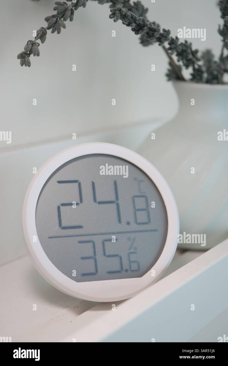 Digital thermometer displaying temperature and humidity indoors Stock ...