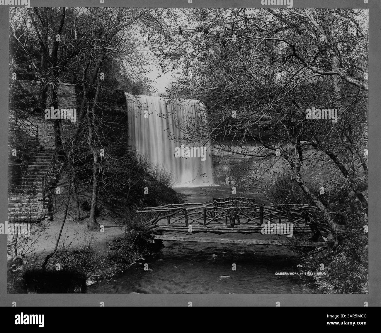 This photograph compares the iconic Minnehaha Falls with the nearby bridge, showcasing a scenic view of the natural landmark and man-made structure in Minneapolis. The falls are a well-known attraction, drawing visitors to the area for their beauty and historical significance. Stock Photo