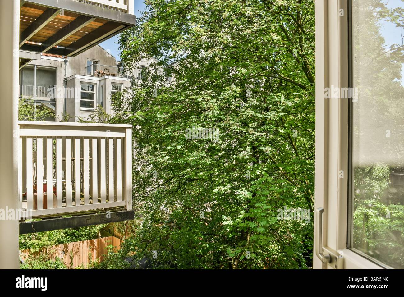 the outside of a house with trees and bushes in front of it, as seen ...