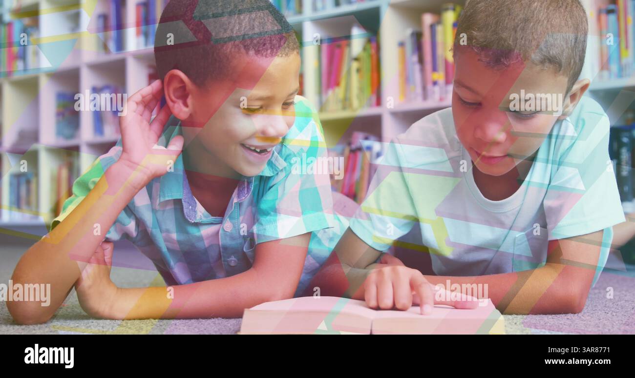 Image of books moving over happy schoolboys reading book at school ...