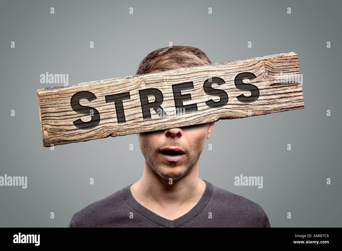 Wooden stress sign in front of a person's face Stock Photo