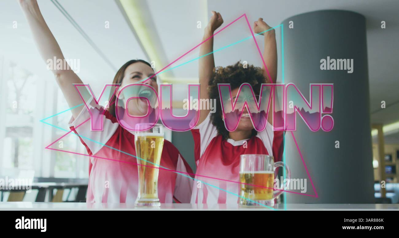 Image of you win text over happy diverse female friends raising hands and drinking beer Stock Photo