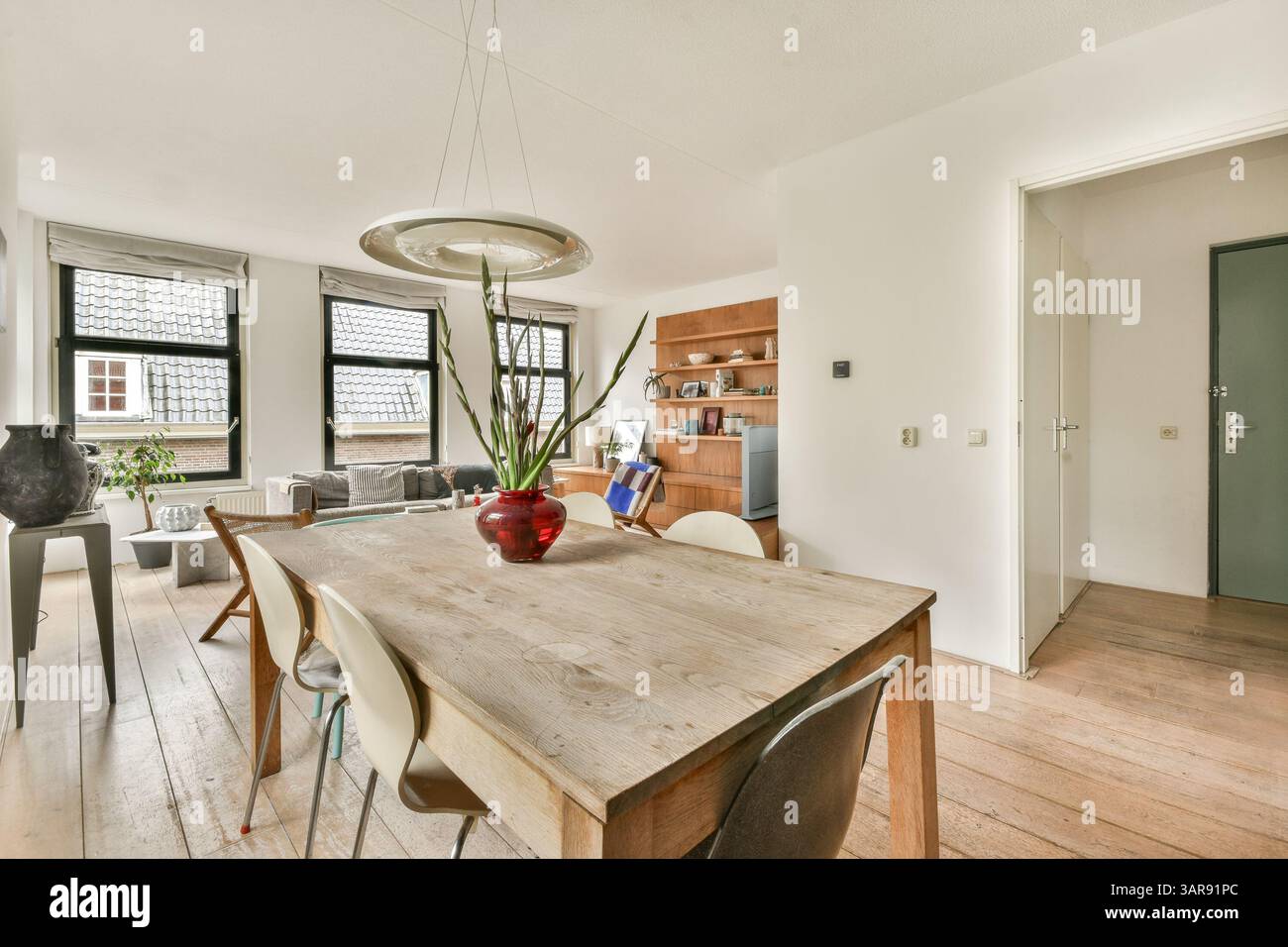 A stylish modern dining room featuring sleek furniture, natural light ...